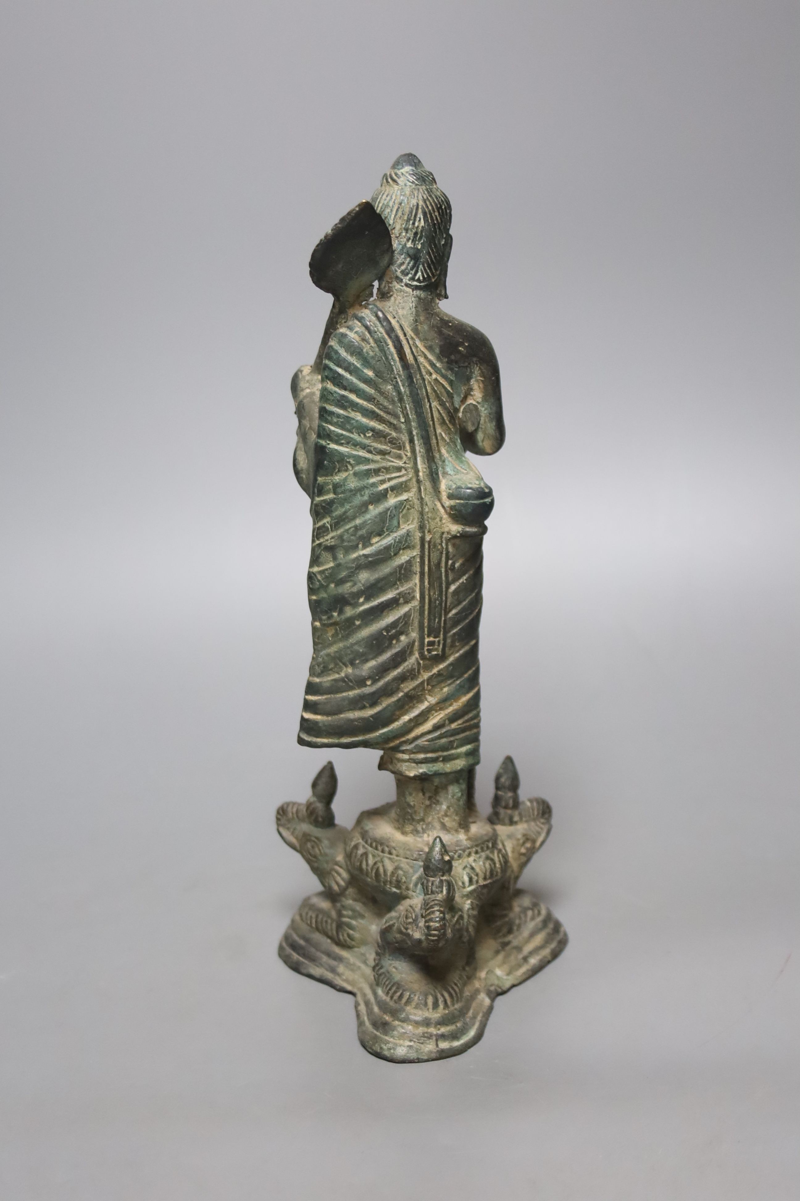An Indian bronze figure of a standing Buddha, 25cm